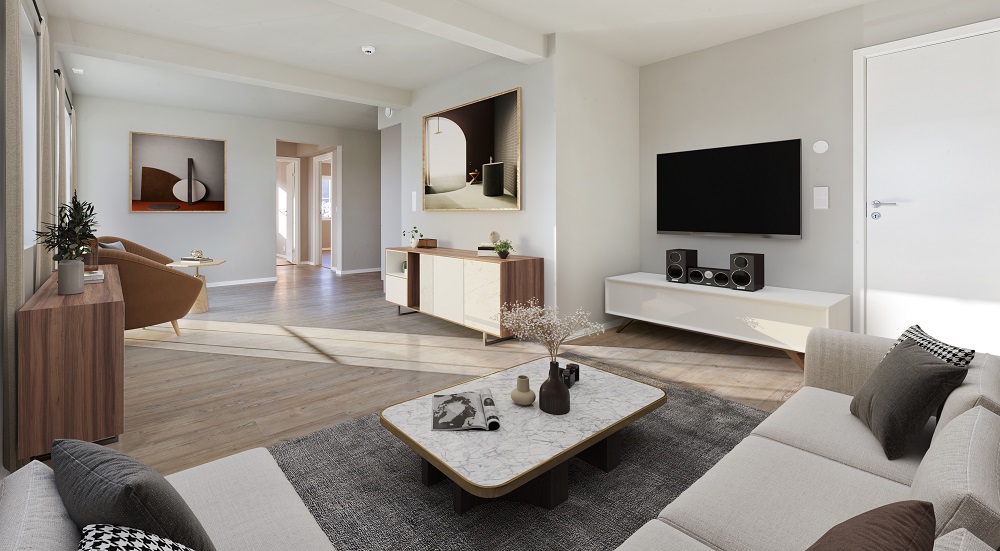 Stue sett fra lysegrå hjørnesofa, lyse farger på vegger og tak, grå-brun parkett, matchende møblement. Foto. 